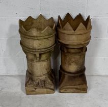 A pair of weathered buff terracotta chimneys. Height 77cm