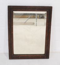 A framed bevel edged wall mirror with etched decoration depicting birds - length 32cm, height 42cm