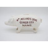 A reproduction cast iron money bank in the form of a pig with advertising to side Wm Molands Sons,