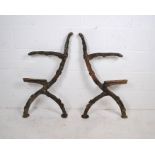 A pair of weathered cast iron twig and branch garden bench ends