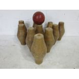 A vintage set of wooden skittles along with a rubber skittle ball