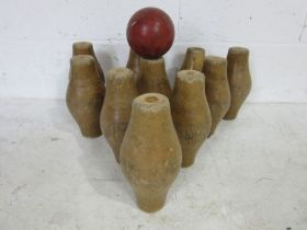 A vintage set of wooden skittles along with a rubber skittle ball