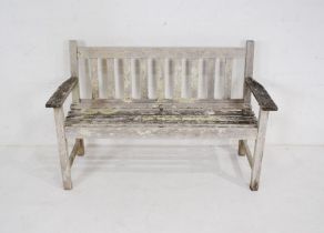 A 'Green Brothers Lister Teak' weathered garden bench with slatted seat - length 128cm, depth