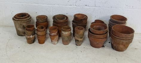 A collection of various sized terracotta garden pots