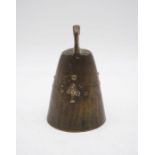 A bronze cow bell with broad arrow mark to either side