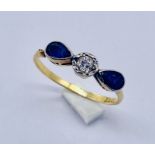 A diamond and sapphire 3 stone ring with teardrop shaped sapphires set in 18ct gold A/F