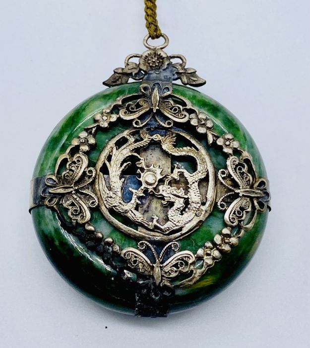 A Japanese green hardstone pendant with SCM decoration of a dragon and pheonix chasing the flaming - Image 3 of 3