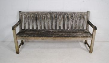 A weathered wooden slat-back garden bench - length 184cm