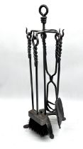 A hand forged fire side companion set.