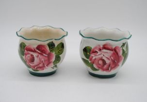 A near pair of Wemyss ware pots, one A/F