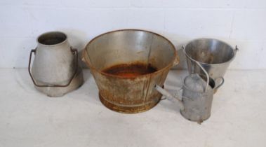 A large galvanised bucket, along with a watering can etc.