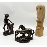A Veronese resin figure group of two horses and a foal dated 2005 along with a carved wooden owl and