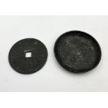 A large Chinese bronze coin along with a Chinese bronze dish with fish detail and character mark