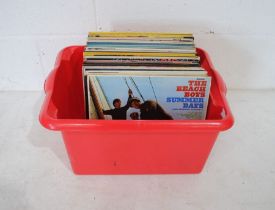 A collection of mostly 60's 12" vinyl records, including The Beach Boys, The Monkees, The Walker