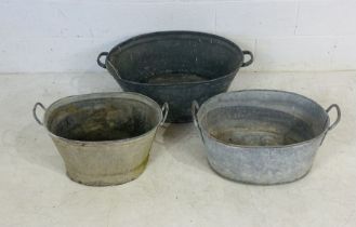 Three vintage galvanised baths