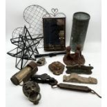 A collection of various items including door knockers, mirrored back candle holder, wirework