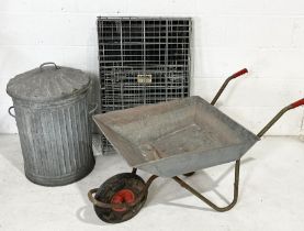 A galvanised lidded bin, wheelbarrow and foldable animal crate