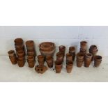 A collection of various sized terracotta garden pots