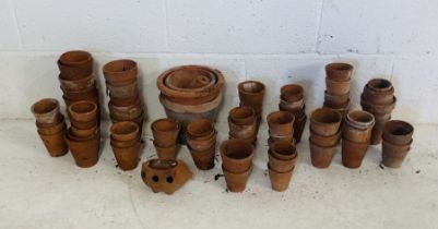 A collection of various sized terracotta garden pots