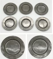 A collection of antique pewter dishes along with two chargers marked for P & D London