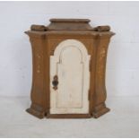A Continental painted wooden wall hanging cupboard with scroll decoration - length 62cm, depth 31cm,