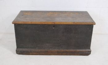 An antique pine trunk with rope handles.