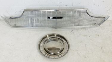 A chrome Austin radiator grill along with an Austin hubcap