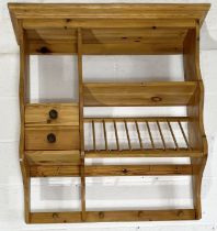 A pine wall hanging plate rack with two drawers