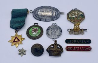 A small collection of badges and medallions including Librarian and Longleat Railway enamelled