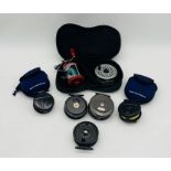 A collection of fly fishing reels including two Ron Thompson Dynadisc reels in soft cases, two The