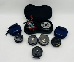 A collection of fly fishing reels including two Ron Thompson Dynadisc reels in soft cases, two The