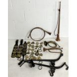 A collection of horse brasses, including Victorian examples, copper horns, horse hames etc.