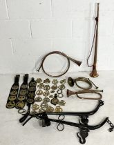 A collection of horse brasses, including Victorian examples, copper horns, horse hames etc.