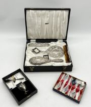 A cased hallmarked silver dressing table set along with a silver plated christening set etc.
