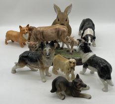 A collection of dog figurines including a Beswick Corgi, Melba Ware etc along with a Juliana