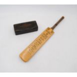 A miniature cricket bat with facsimile signatures of the 1967 England team, along with a papier-