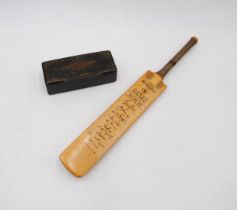 A miniature cricket bat with facsimile signatures of the 1967 England team, along with a papier-
