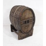 An antique coopered barrel on stand - length 54cm, depth 46cm, height 80cm