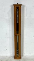 A Griffin & George stick barometer in wooden case with key.