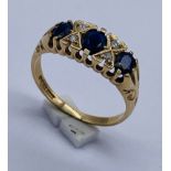 A 9ct gold sapphire three stone ring with diamond infills