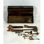 A vintage wooden tool chest marked E.D, with a small selection of woodworking tools.