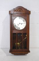 An Edwardian carved oak wall clock - length 34cm, height 77cm