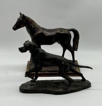 Two resin animal statues a horse and a pointer/gun dog.