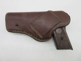 An Italian cap gun in leather holster