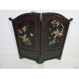 A small two fold Japanese lacquered screen with bone decoration, some losses