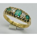 An 18ct gold emerald and diamond 5 stone ring