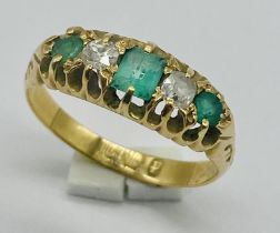 An 18ct gold emerald and diamond 5 stone ring