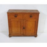 An antique pine narrow dresser base with two drawers stamped 'W' and 'K' and cupboard under - length