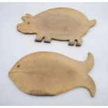 Two vintage wooden bread boards, in the form of a pig and a fish