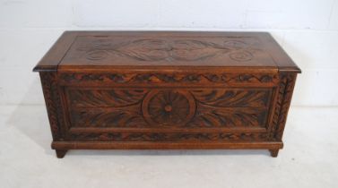 An oak blanket box, with carved decoration - length 107cm, depth 46cm, height 47cm